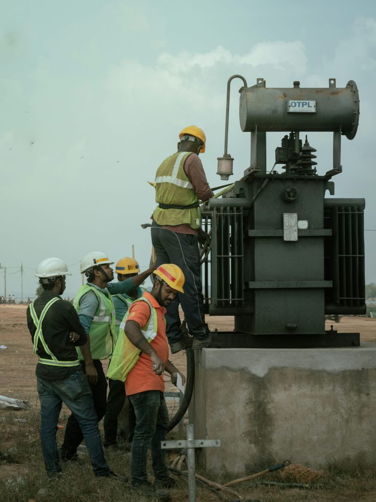 a group of men standing around a machine