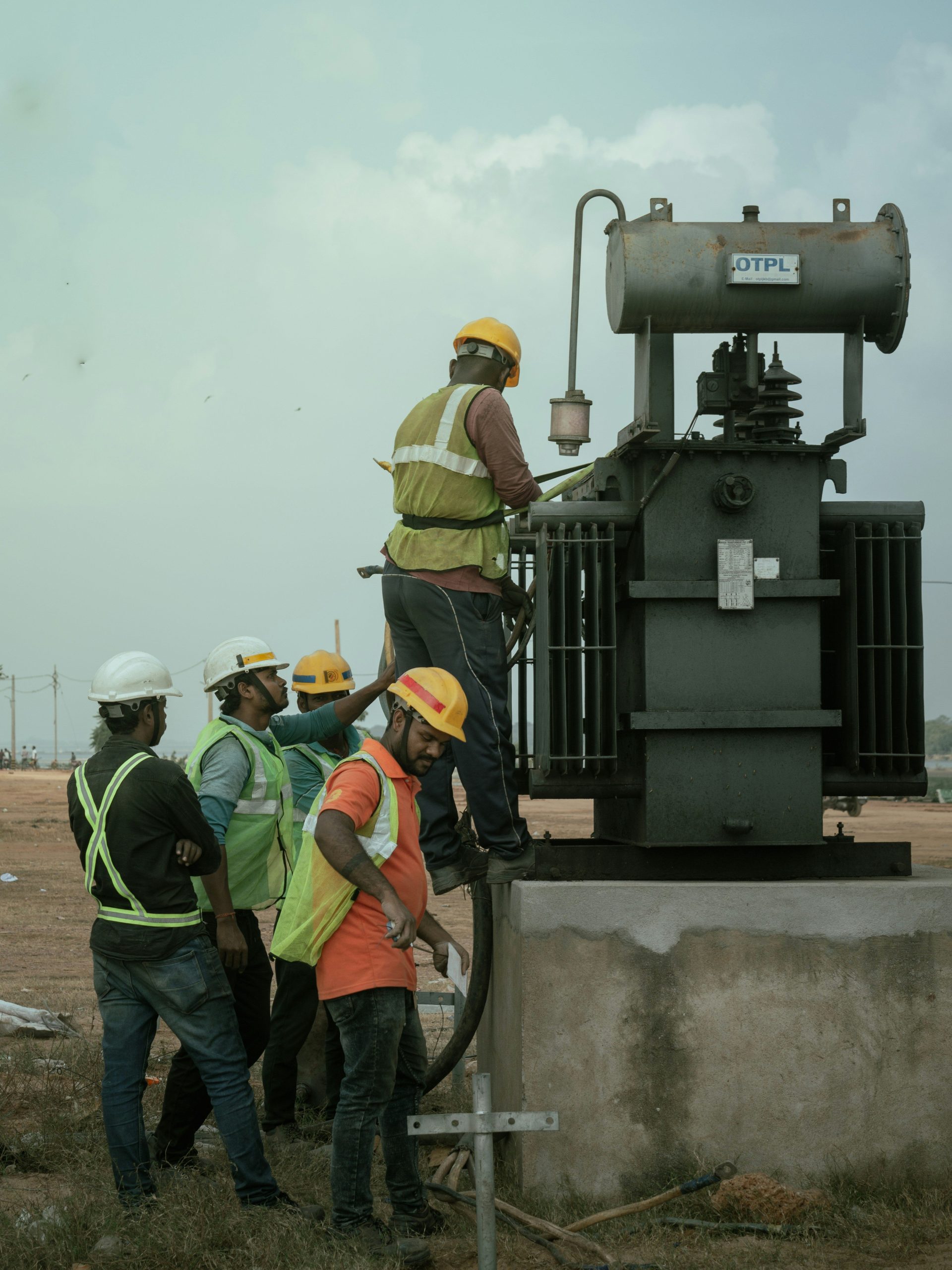 a group of men standing around a machine