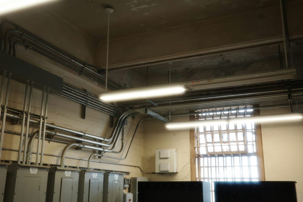 The room shows electrical wiring and lighting fixtures.